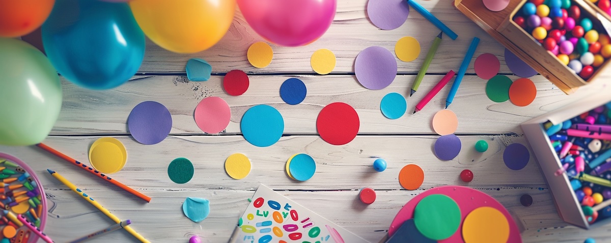 Basteltisch auf einem Kindergeburtstag mit Buttonmaschine, ausgemalten Motiven und fertigen Buttons